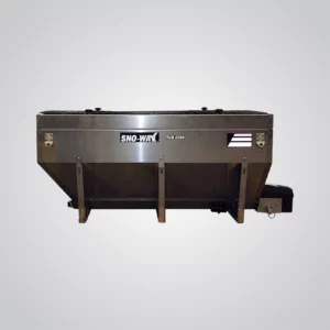 A Sno-Way Revolution V-Box Spreader, specifically an RVB2500 model, is showcased against a light grey background. The spreader is constructed of stainless steel. The "SNO-WAY" logo is visible on the side, along with the model designation "RVB 2500". The spreader has a rectangular hopper shape, tapering down towards the dispensing mechanism at the bottom right. Black components of the motor and spreading apparatus are visible. The overall impression is of a durable and corrosion-resistant piece of equipment designed for spreading materials.
